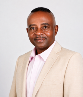Dr. Clement Iyoha in tan blazer